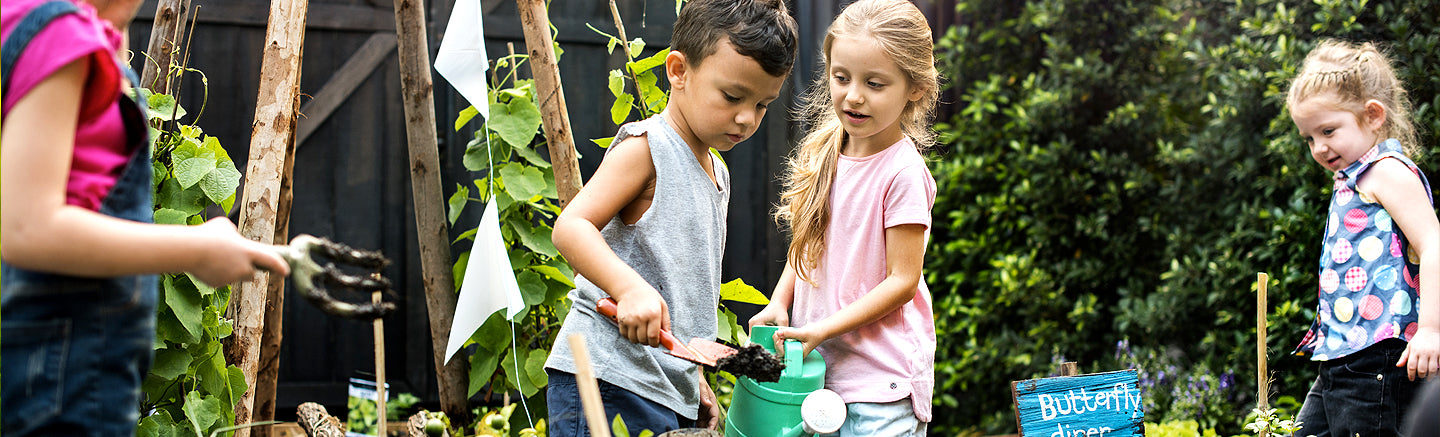 Kids playing with a can o worms compost