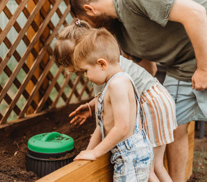 young children burrying a worm buffet