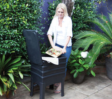 mom putting in kitchen waste inside a worm cafe