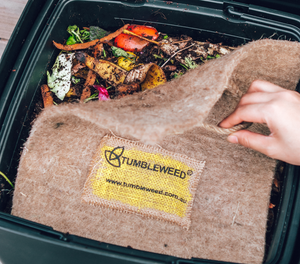 Square worm blanket covers a bin filled with organic materials