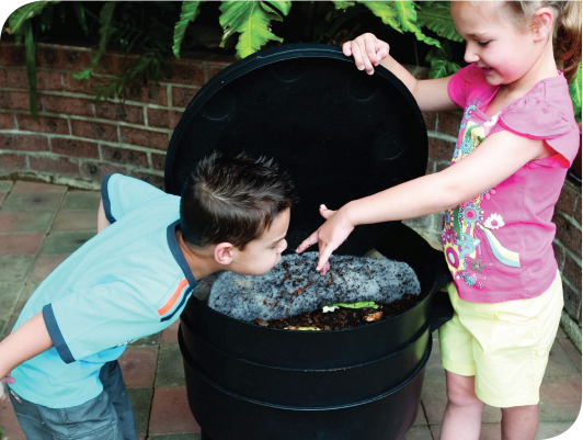 children looking at a worm fam